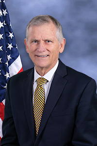 Director Kerr in front of flag