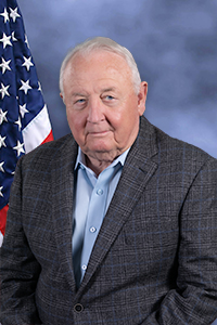 Director Parker in front of flag