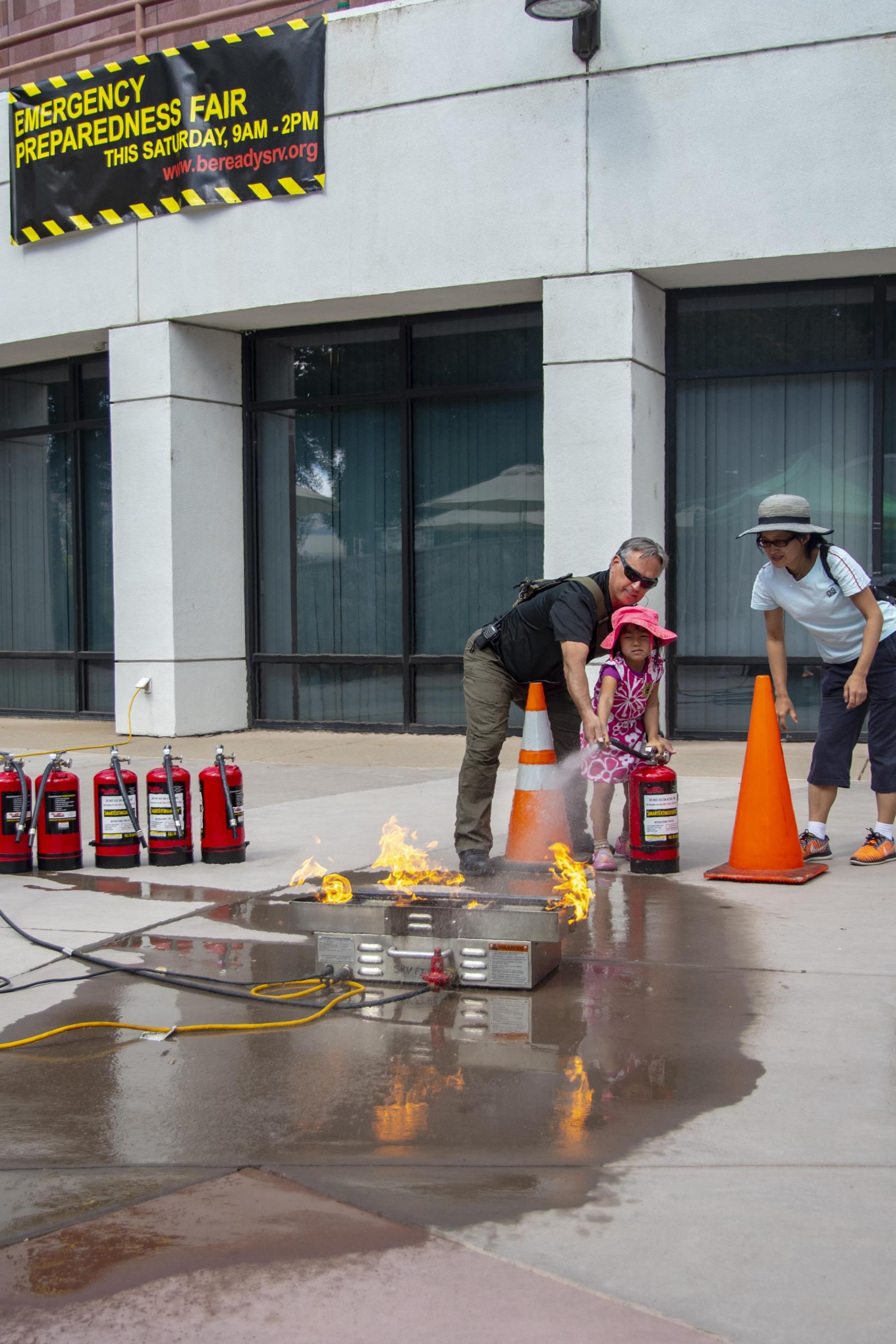 Girl learns how to use extinguisher