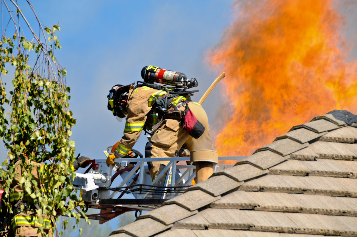 ladder on roof with flames