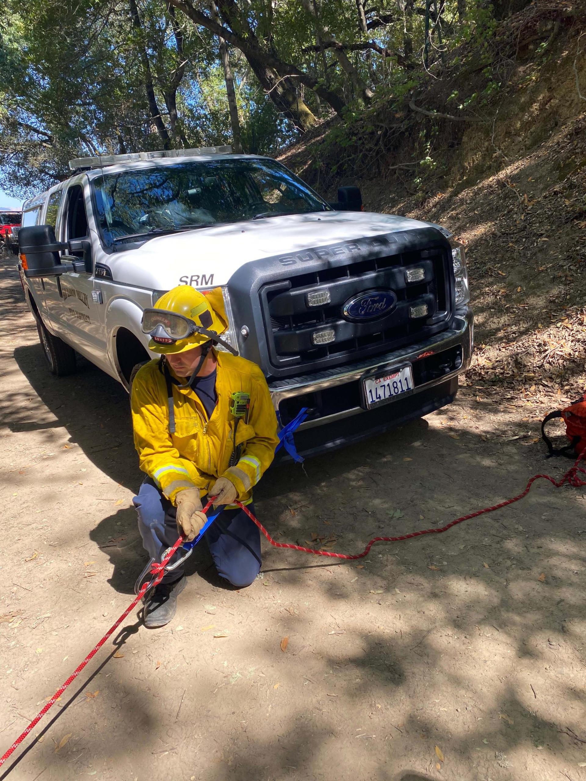 Firefighter operates rope system