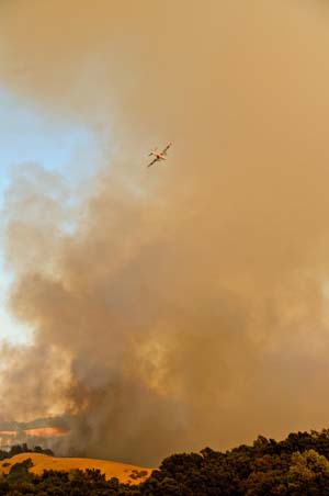 Plane Flying in Smoky Sky